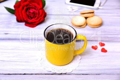 Yellow cup with hot black coffee