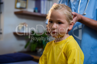 Female doctor examining a little girl