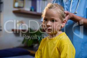 Female doctor examining a little girl