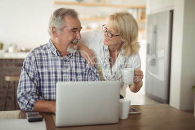 Senior couple using laptop