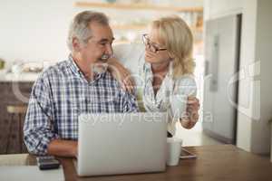 Senior couple using laptop