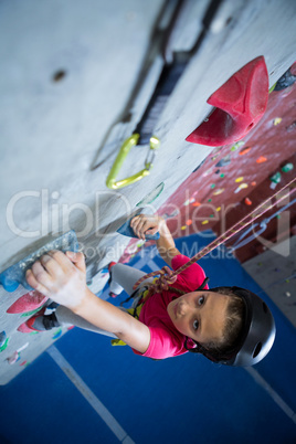 Teenage girl practicing rock climbing