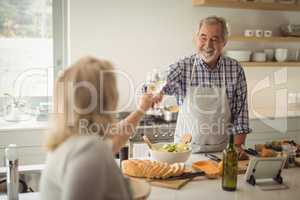 Senior couple toasting wine glasses