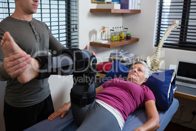 Male physiotherapist giving leg massage to patient