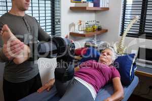 Male physiotherapist giving leg massage to patient