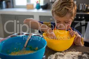 Boy preparing food in yellow bowl