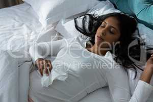 Sick young woman sleeping on bed