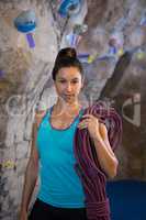 Woman holding rope in fitness studio