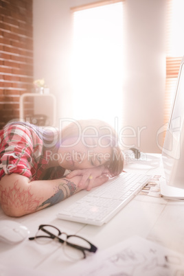 Female executive sleeping at her desk