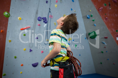 Boy standing with rope in fitness studio