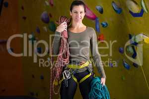 Happy woman with rope in fitness studio