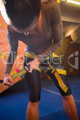 Determined woman wearing safety harness