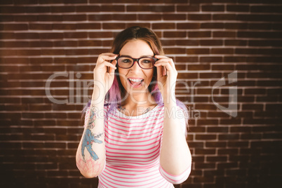 Portrait of smiling woman holding spectacles