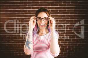 Portrait of smiling woman holding spectacles