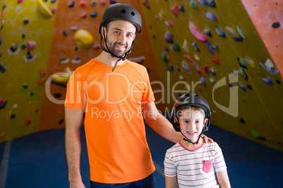 Portrait of trainer and kids standing in fitness studio