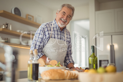 Senior man chopping vegetables at home