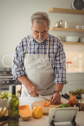 Senior man chopping vegetables