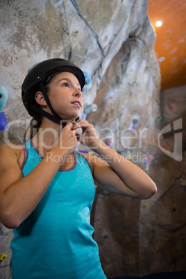 Woman wearing protective helmet in fitness studio