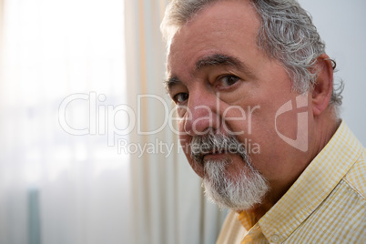 Portrait of serious senior man in retirement home