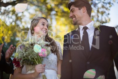 Couple playing with bubbles in park