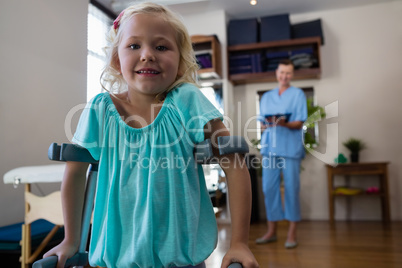 Portrait of smiling girl with crutches