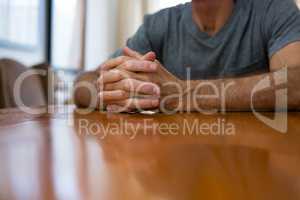 Midsection of senior man sitting at table