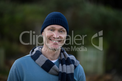 Smiling man in warm clothing standing outdoors