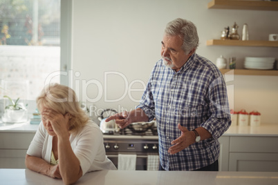 Senior couple arguing in kitchen