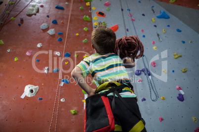 Boy standing with rope in fitness studio