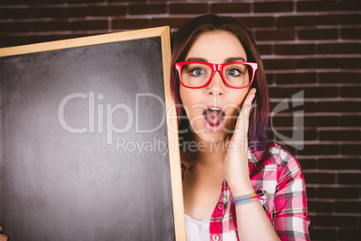 Portrait of shocked woman holding slate