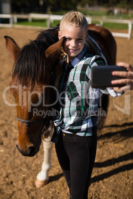 Girl taking a selfie with horse