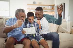 Multi-generation family using digital tablet in living room