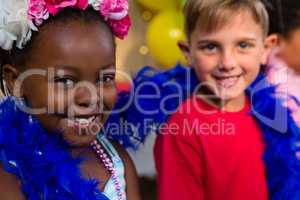 Portrait of children with feather boa