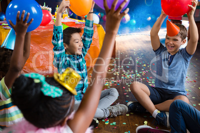 Cheerful children playing with balloon