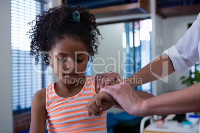 Physiotherapist giving hand massage to a girl