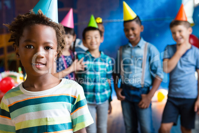 Portrait of girl wearing party hand with friends in background