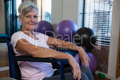 Portrait of smiling senior woman on wheelchair