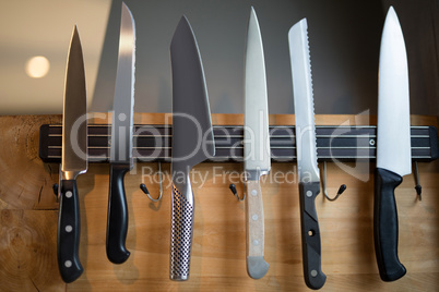 Set of kitchen knives hanging on the wall