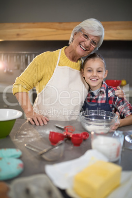 Grandmother and granddaughter embracing in the kitchen