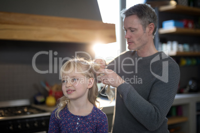 Father styling daughters hair