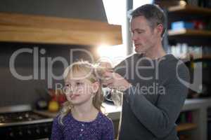 Father styling daughters hair