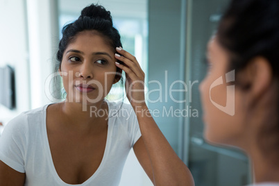 Woman reflecting on mirror