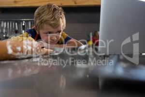 Boy looking at laptop