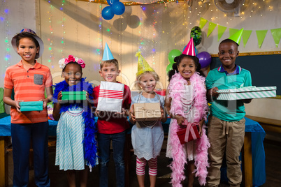 Portrait of children holding gifts