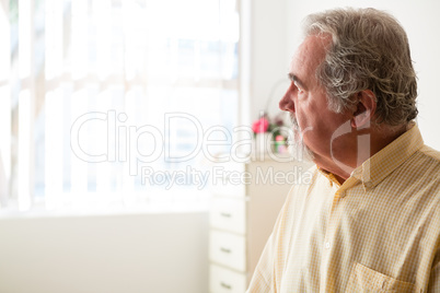 Close up of thoughtful senior man relaxing at nursing home