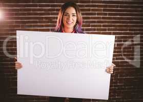 Portrait of smiling woman holding blank sheet