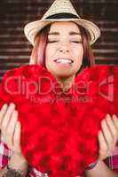 Smiling woman holding heart shape