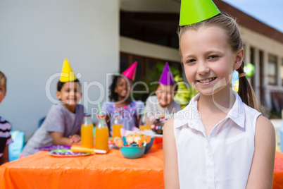 Portrait of smiling girl with friends in background