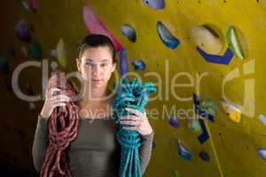 Happy woman with rope in fitness studio