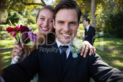 Portrait of happy couple posing in park